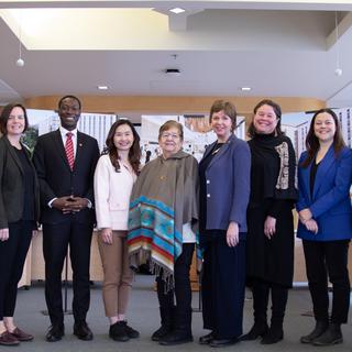 A group poses in the boardroom