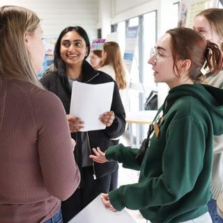 Five students talk to each other at CREATE conference