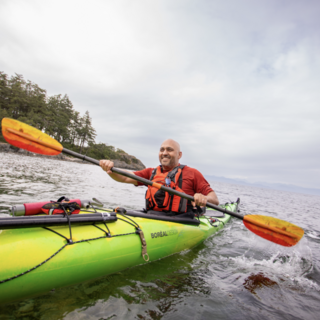 Farhad in a kayak paddling on the ocean