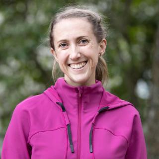 Haley Healey head and shoulders with a forest background