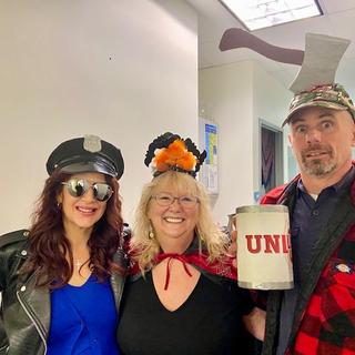 Three people in Halloween costumes