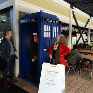 The TARDIS replica in the VIU cafeteria with people around it.