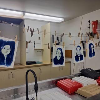 The cyanotype hang from pegs on a string.