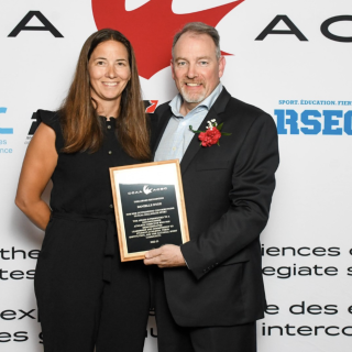 Danielle Hyde on the left receiving her award from a CCAA representative