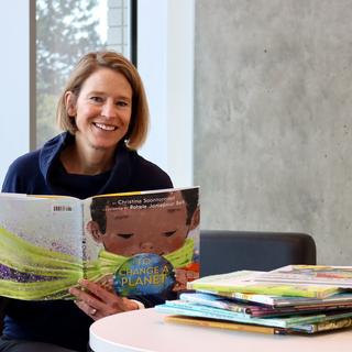 A woman reading childrens picture books 