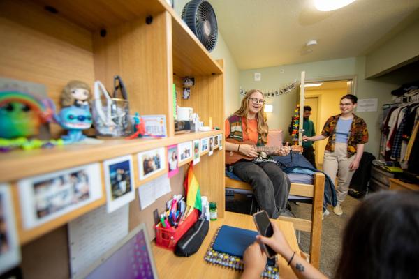 Four students hang out in a dorm