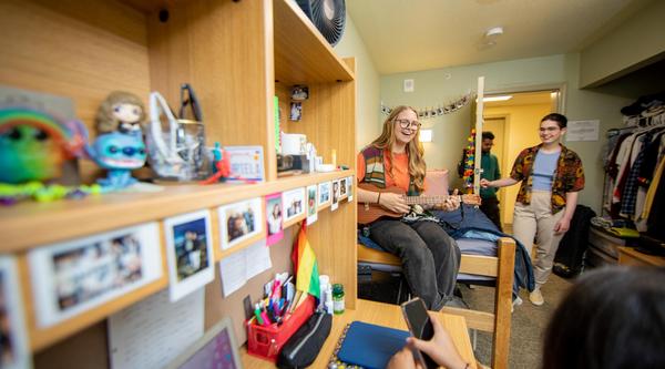 Four students hang out in a dorm