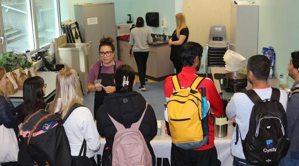 Leah serves food to students