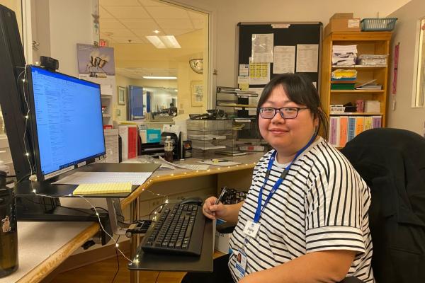 Jingjing sits at a desk in her hospital unit