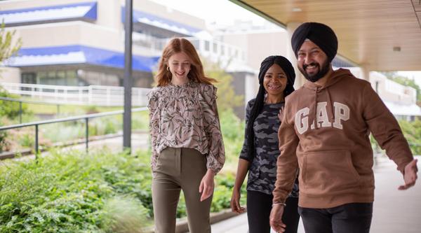 Three students walk by the Health and Science Centre