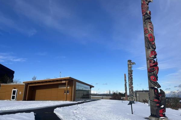 VIU's three totems outside Shq'apthut on the Nanaimo campus