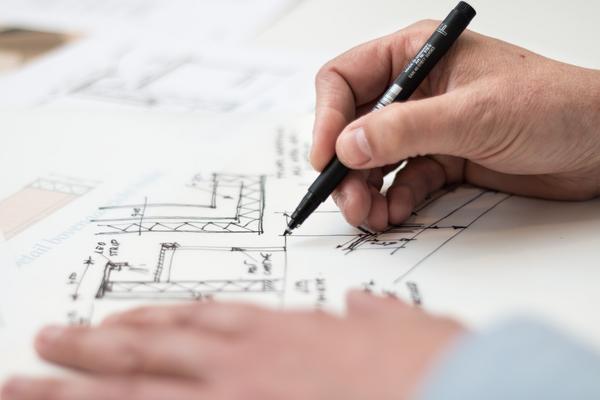 hands sketching an architectural drawing