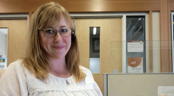 Amanda Rozenboom sitting at her work desk and smiling at the camera