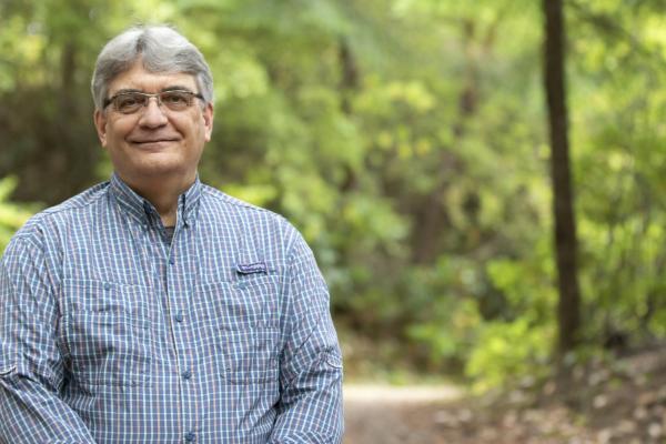 VIU Forestry Professor Bill Beese stands in front of trees.