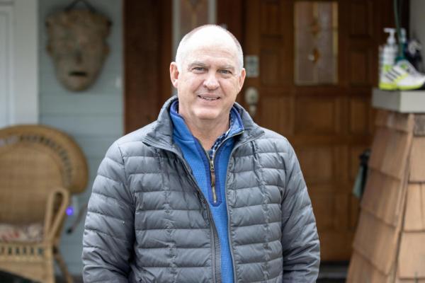 Bruce Barnard stands in front of his house