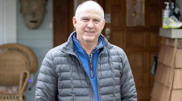 Bruce Barnard stands in front of his house