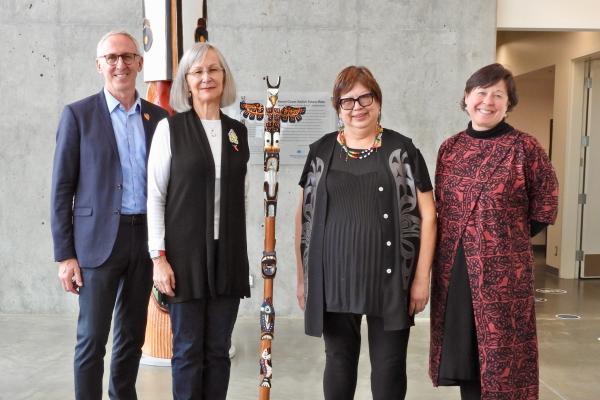 VIU and UVic Presidents and Chancellors pose with the Talking Stick