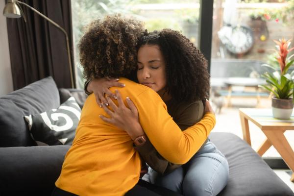 Two women hug