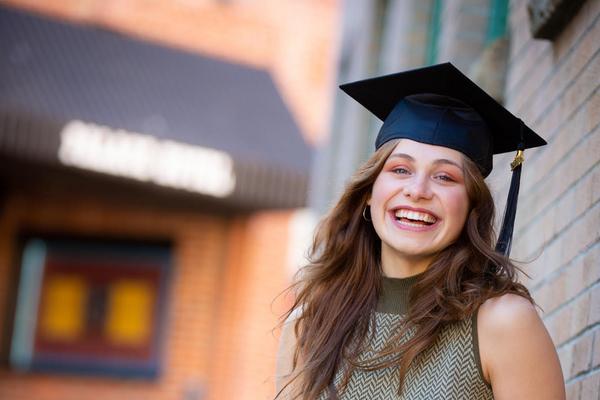 Portrait shot of Lurana wearing a grad cap