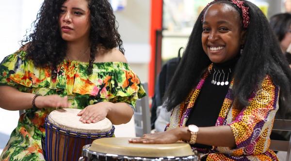 Two women play drums