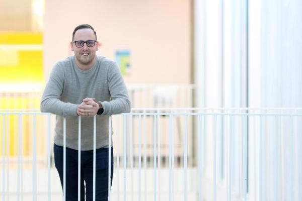 Man leans on railing in VIU's Centre for Health and Science