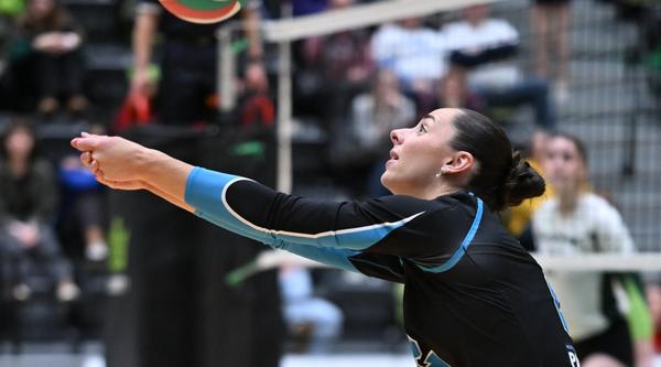 Linea Brickwood gets ready to bump the ball during a Mariners game inside the VIU gym while a crowd watches in the background