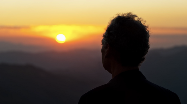 silhouette of a man watching the sunset