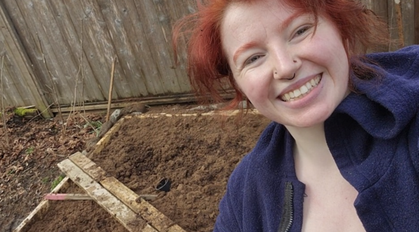 Halle Walle standing in front of her backyard bog and smiling at the camera