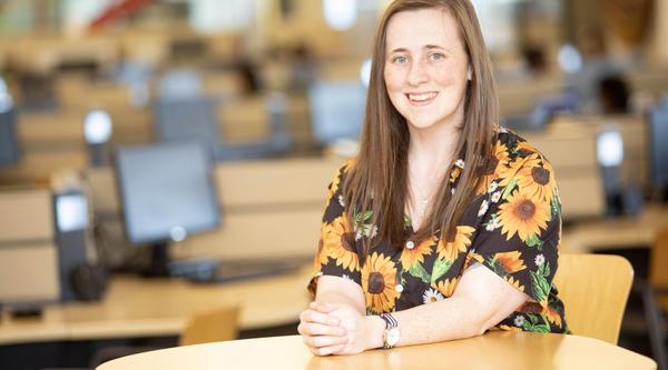 Sherry Wessel sits at a table in the library at VIU's Nanaimo campus