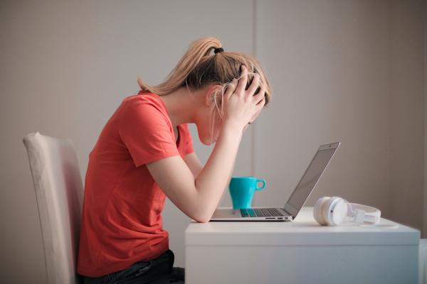 Student sitting at a desk in front of a laptop