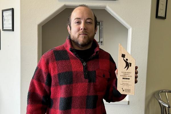 Tyson holds up his Ma Murray award