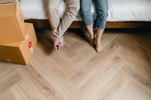 people sitting on a bed with boxes around them