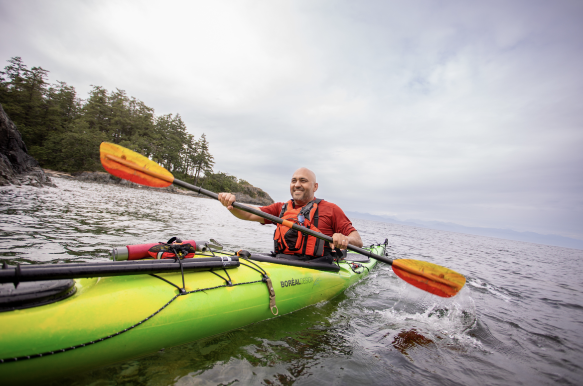 Farhad in a kayak paddling on the ocean