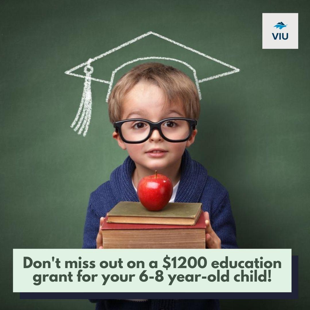 Image of kid holding books and an apple