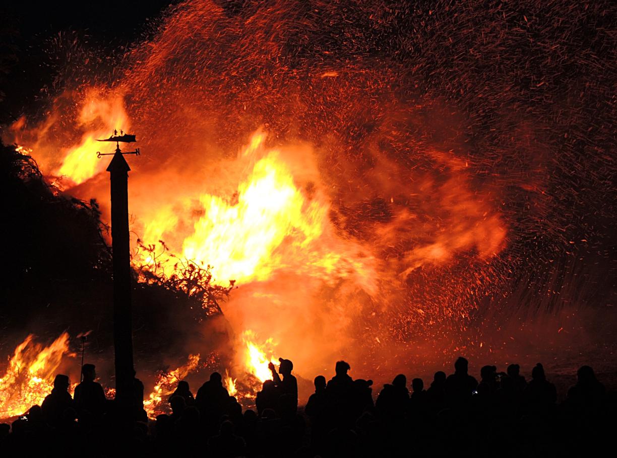 Wildfire with silhouettes of people looking on