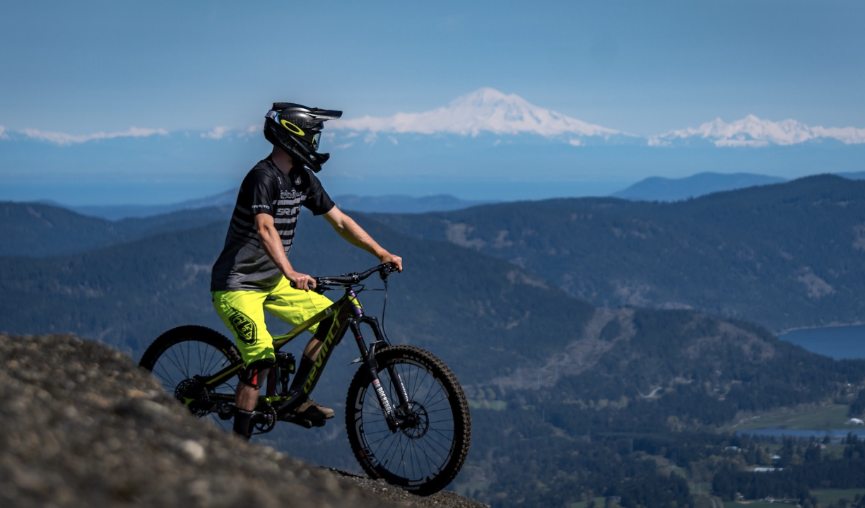 A mountain biker takes in the views on a sunny day