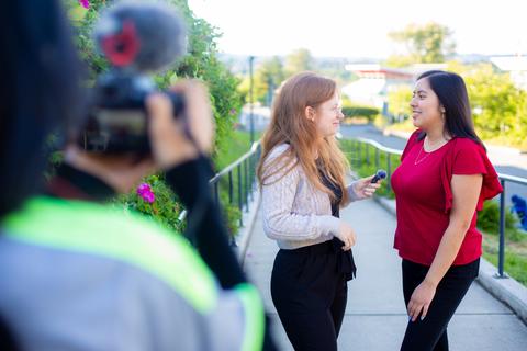 Jay interviews another student and is filmed by a third student