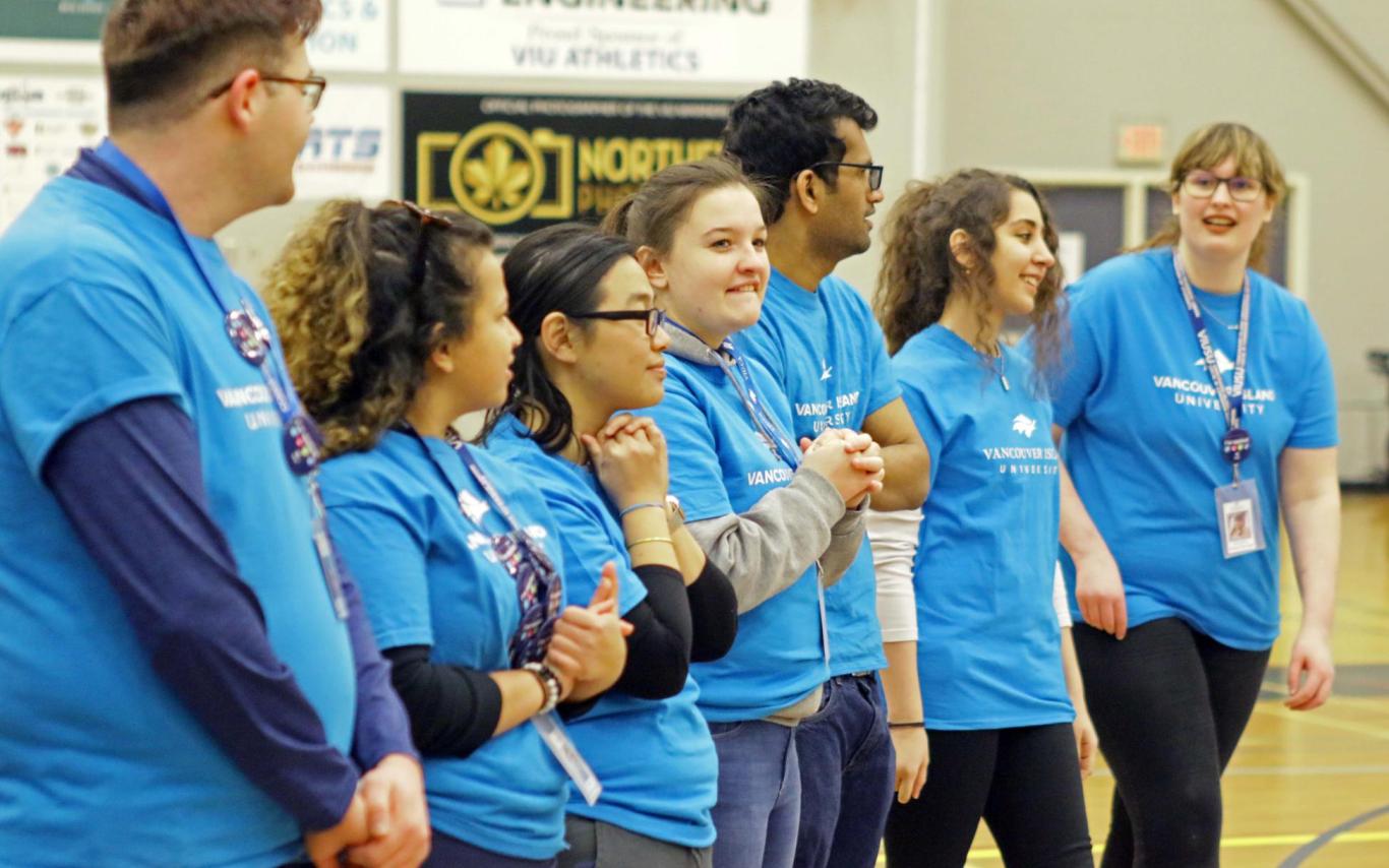 a group of students wearing VIU T-Shirts addresses a crowd
